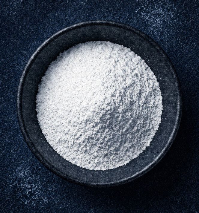 A bowl of glycine powder in blue duotone